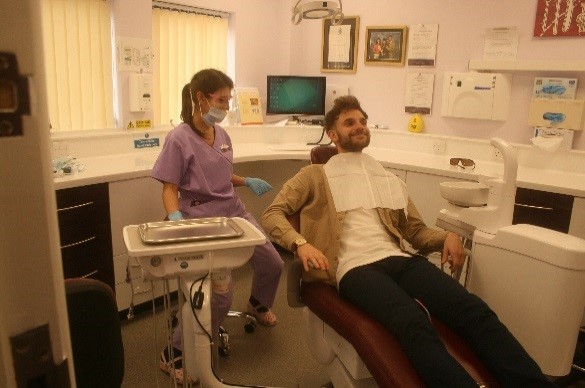 Chloe the Hygienist with a Patient in the Chair