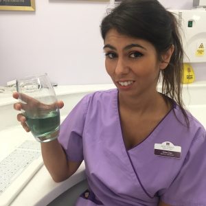 Chloe the hygienist looking dubiously at some mouthwash